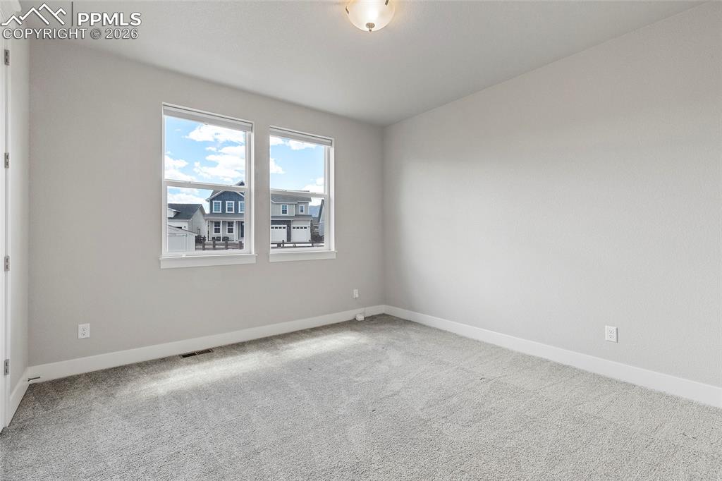 15777 Little Bluestem Road Monument, CO 80132 - Photo 25 of 50 an empty room with windows
