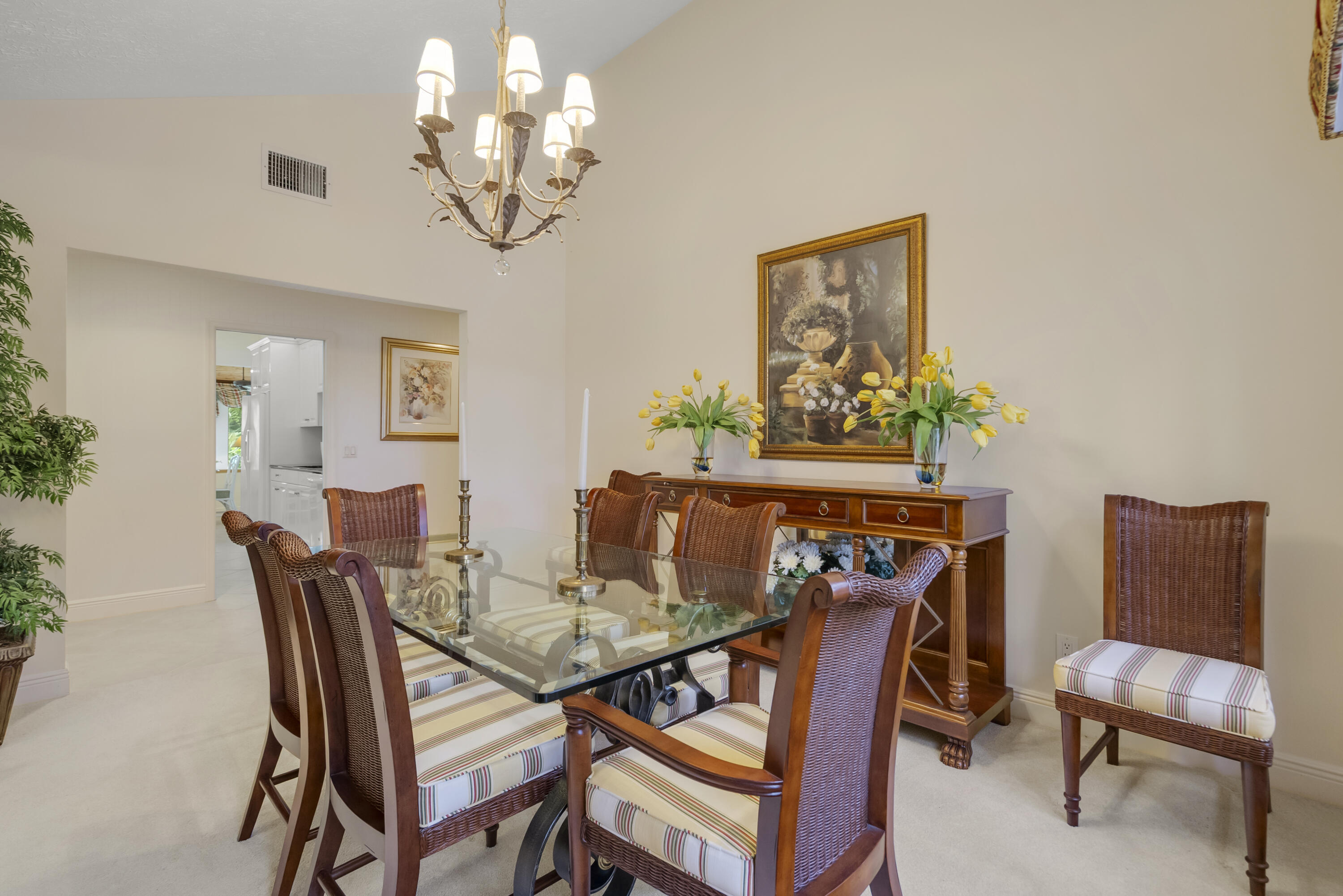 5011 Southeast Burning Tree Circle Stuart, FL 34997 - Photo 19 of 59 a view of a dining room with furniture and a chandelier
