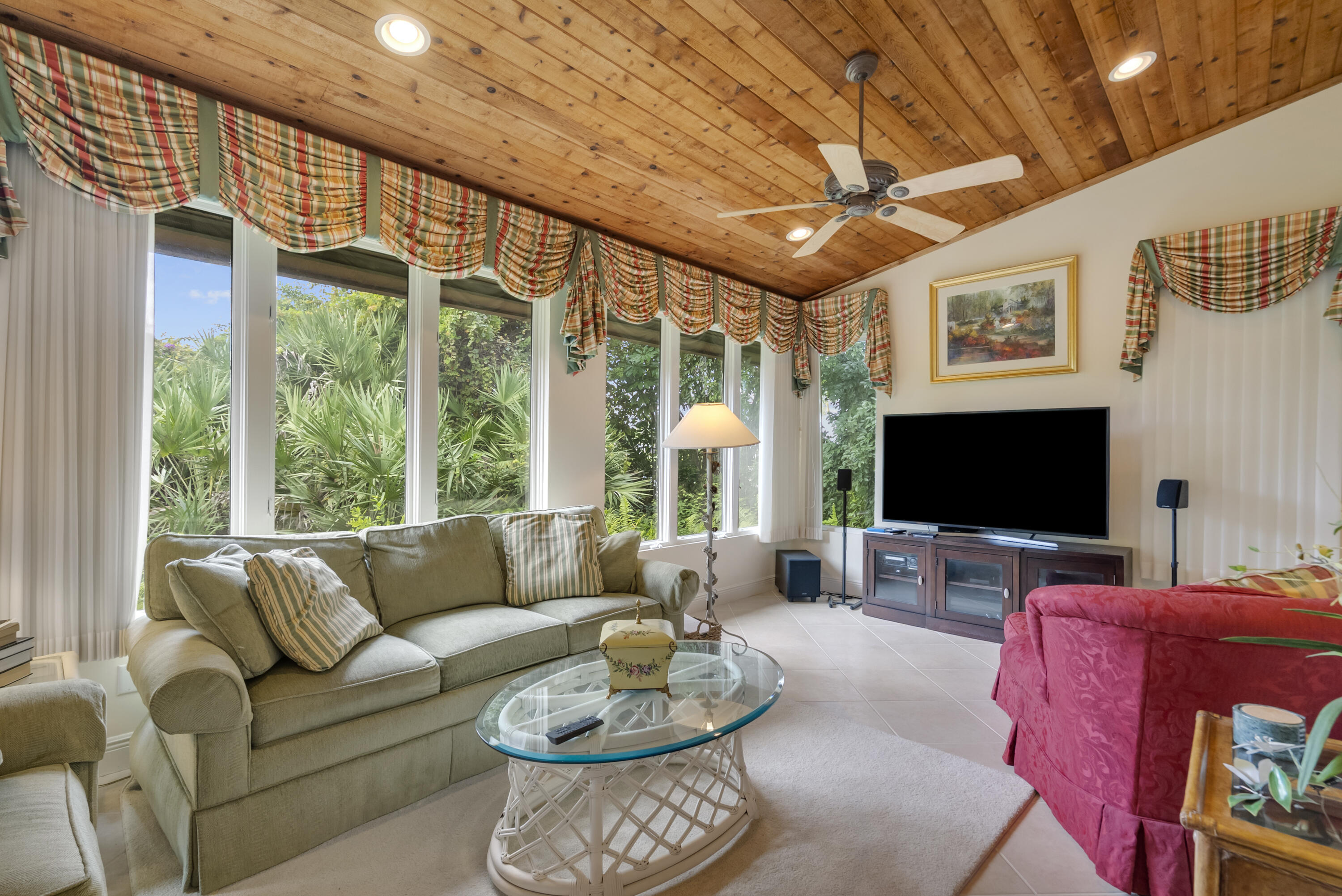 5011 Southeast Burning Tree Circle Stuart, FL 34997 - Photo 21 of 59 a living room with furniture a large window and a flat screen tv