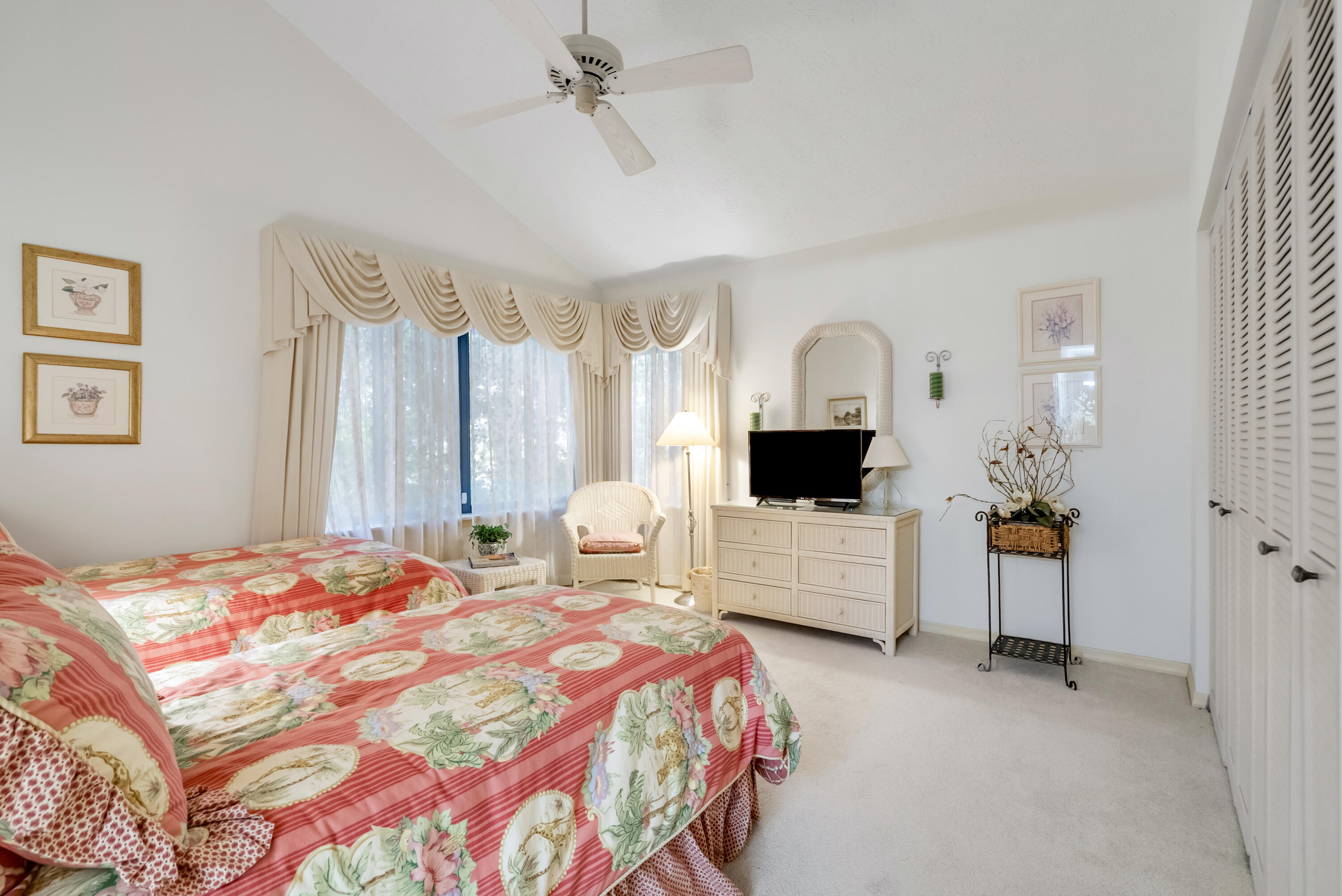 5011 Southeast Burning Tree Circle Stuart, FL 34997 - Photo 32 of 59 a bedroom with a bed a window and dresser