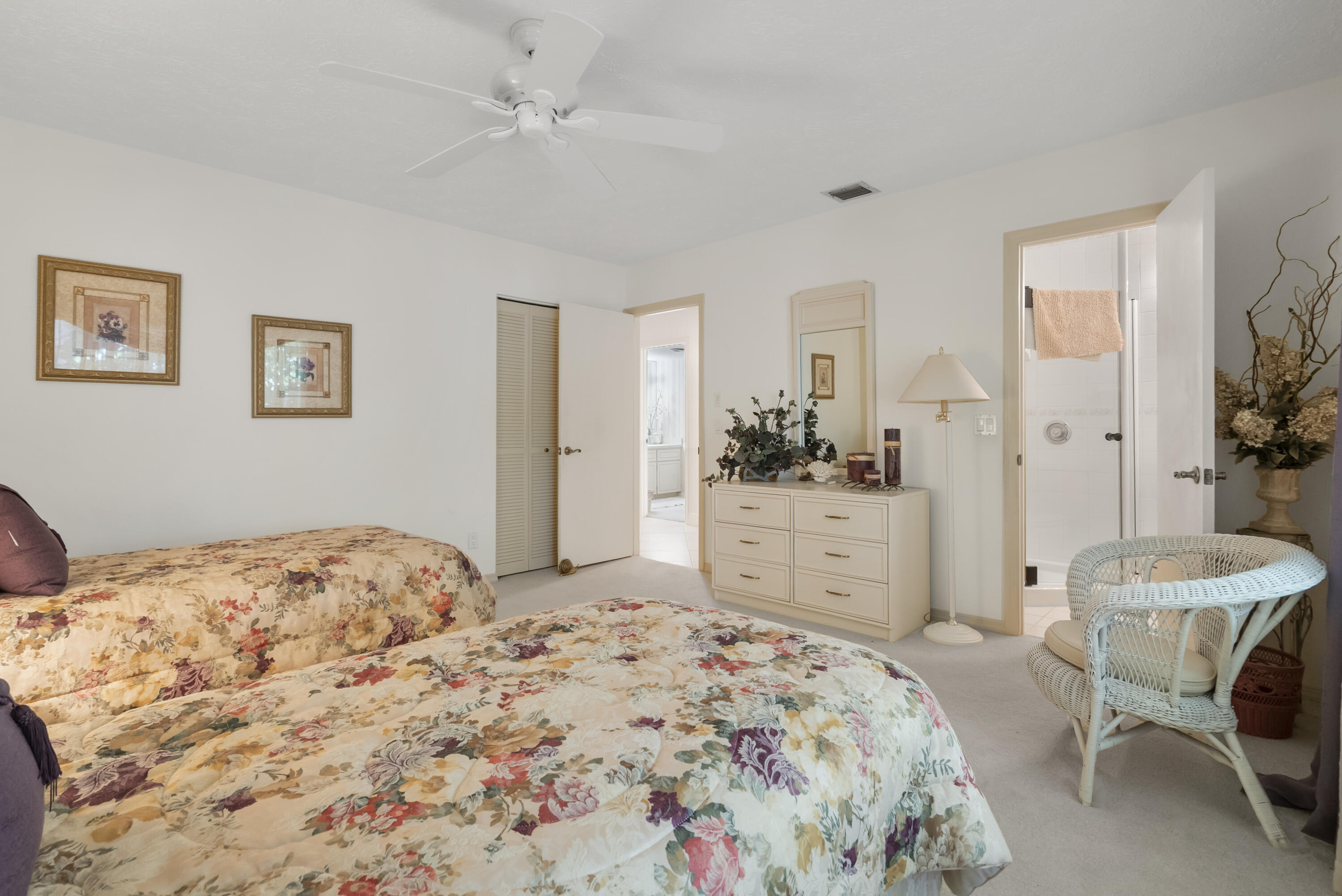 5011 Southeast Burning Tree Circle Stuart, FL 34997 - Photo 36 of 59 a bedroom with a bed and a dresser