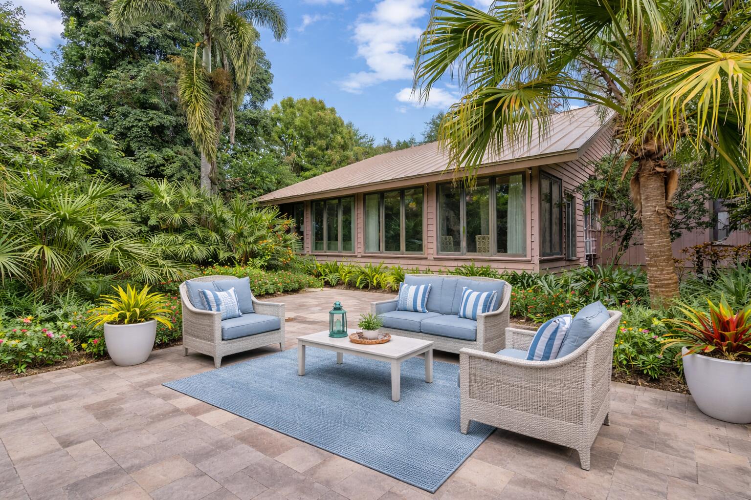 5011 Southeast Burning Tree Circle Stuart, FL 34997 - Photo 40 of 59 a view of a patio with couches and a potted plant