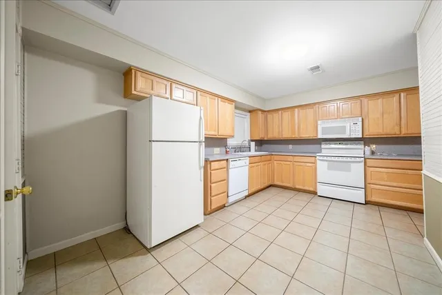 a kitchen with a refrigerator sink and cabinets