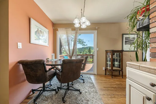 a view of a dining room with furniture a chandelier and wooden floor