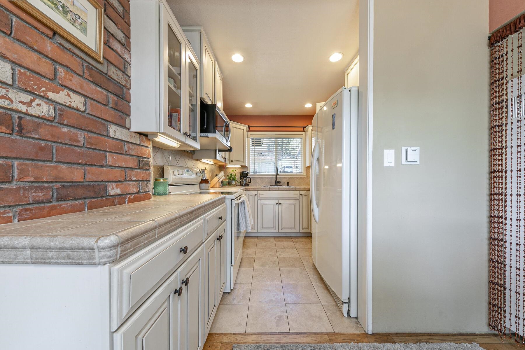 11629 Brook Lane Truckee, CA 96161 - Photo 15 of 28 a kitchen with white cabinets and white appliances