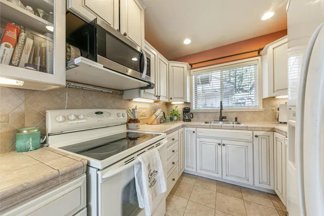 a kitchen with a sink stove and cabinets