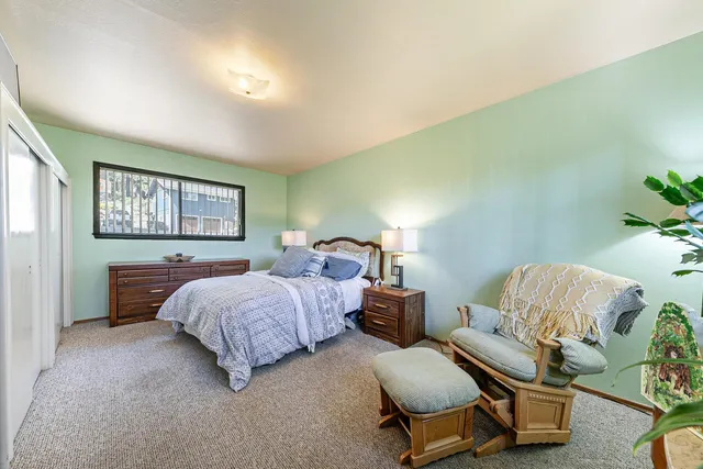 a bedroom with a bed and window