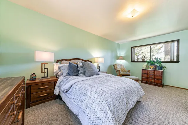 a bedroom with bed and window