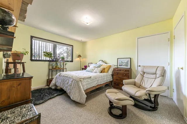 a bedroom with furniture and a window