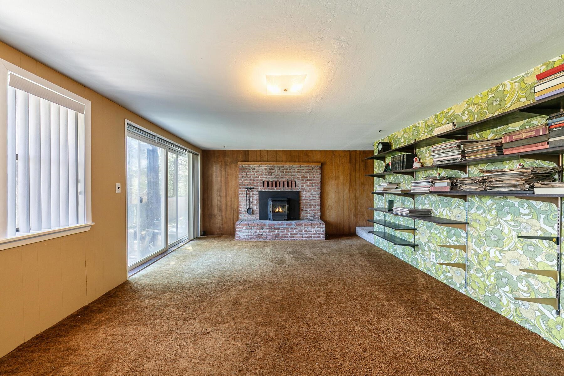 11629 Brook Lane Truckee, CA 96161 - Photo 22 of 28 a view of an empty room with a fireplace and a window