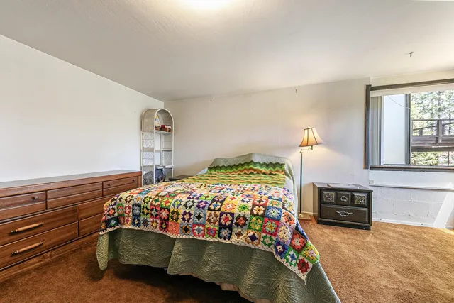 a bedroom with a bed and a fireplace