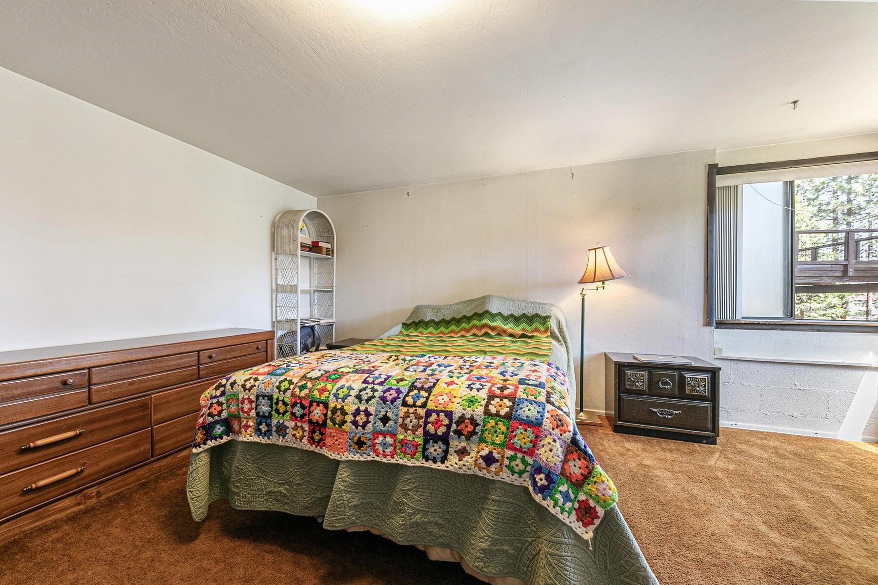 11629 Brook Lane Truckee, CA 96161 - Photo 23 of 28 a bedroom with a bed and a fireplace