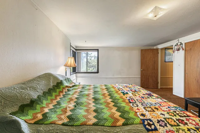 a bedroom with a bed and a window