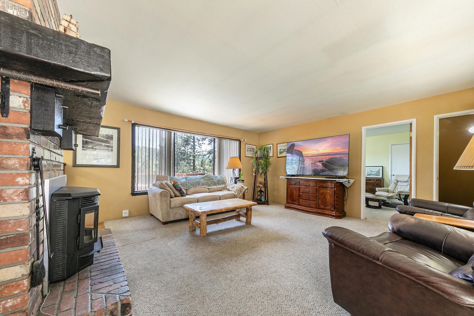 11629 Brook Lane Truckee, CA 96161 - Photo 8 of 28 a living room with furniture a flat screen tv and a fireplace