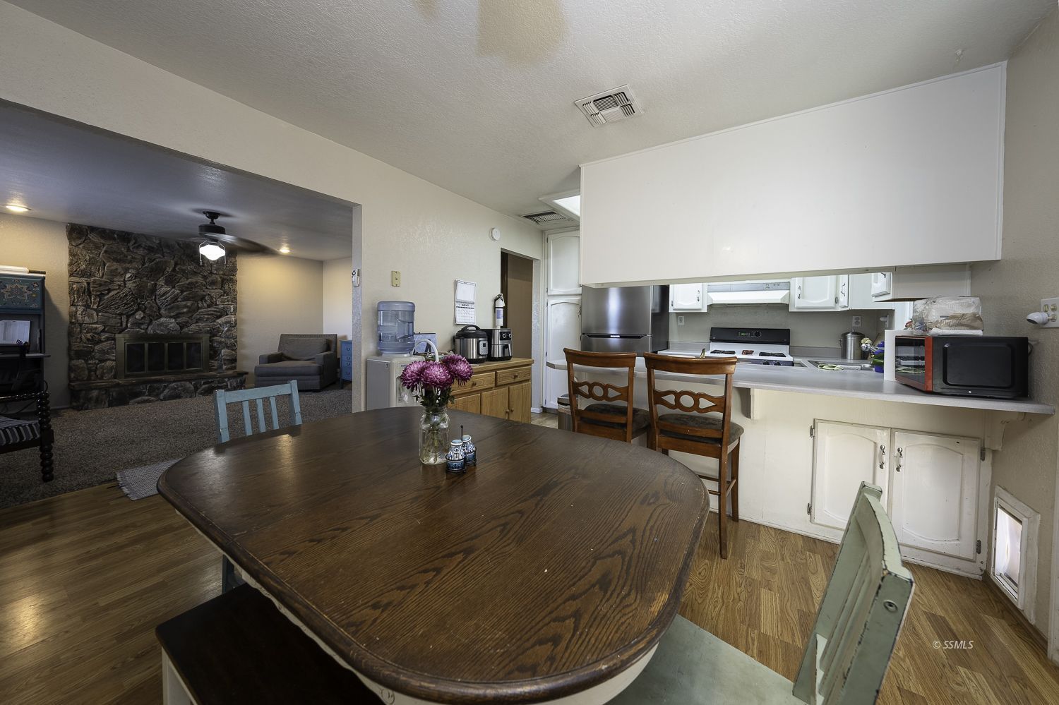 617 South Downs Street Ridgecrest, CA 93555 - Photo 4 of 34 a kitchen with sink a refrigerator and chairs