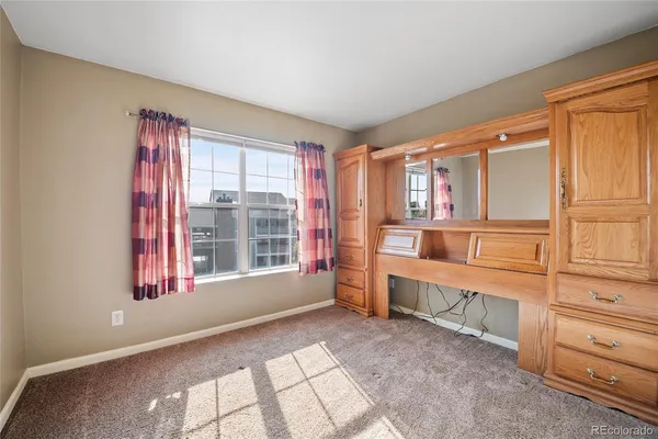 a view of a bedroom with window and furniture