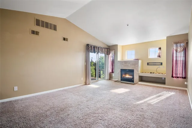 a view of an empty room with a fireplace