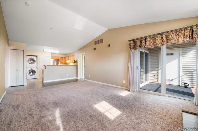 a view of a big room with closet and windows
