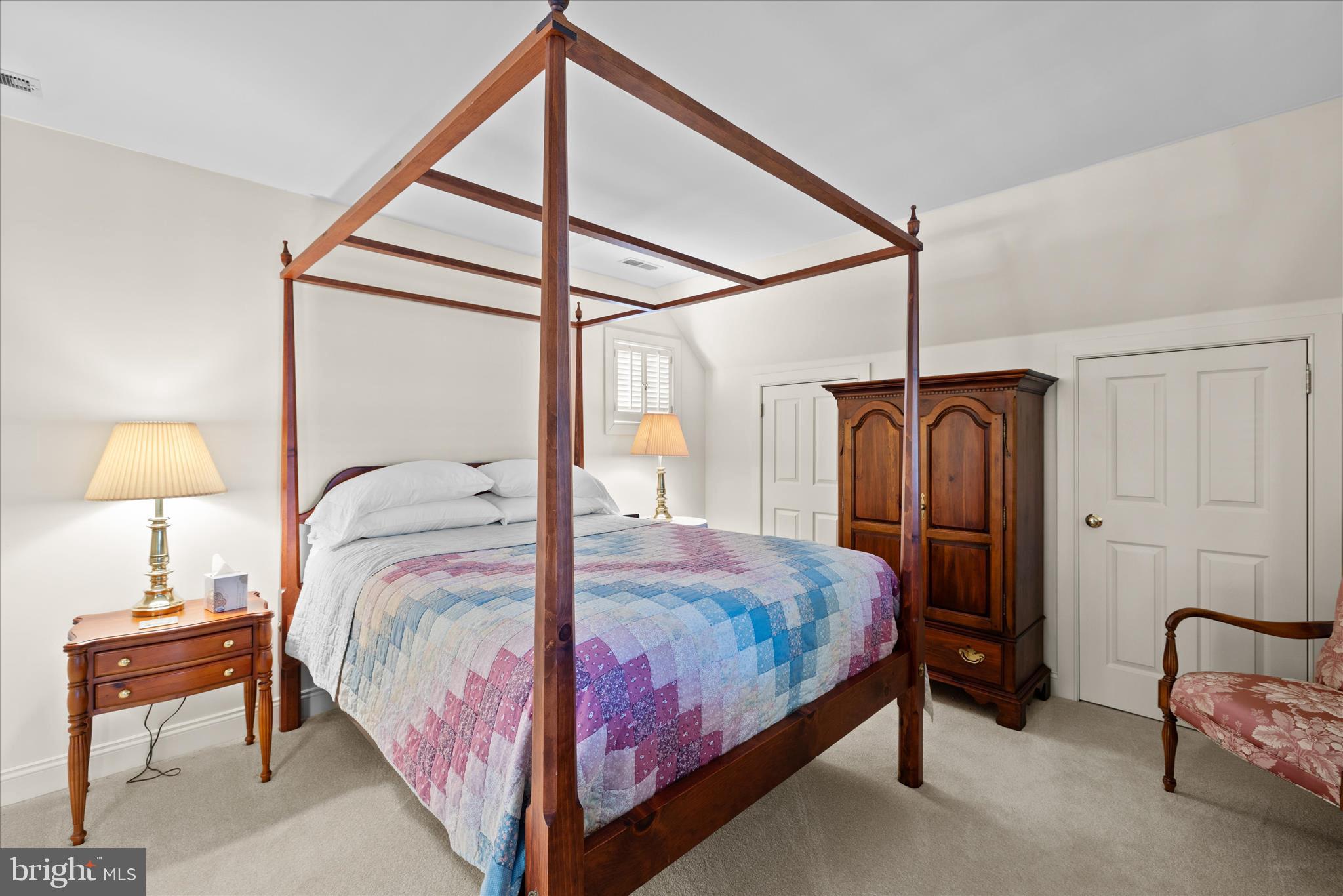 27473 Westpoint Road Easton, MD 21601 - Photo 51 of 58 a bedroom with a bed and a lamp