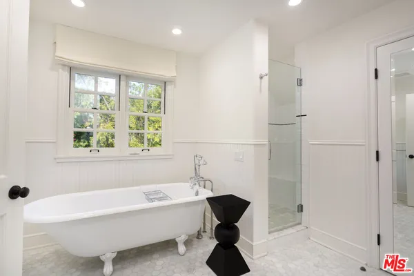 a bathroom with a bathtub and a shower