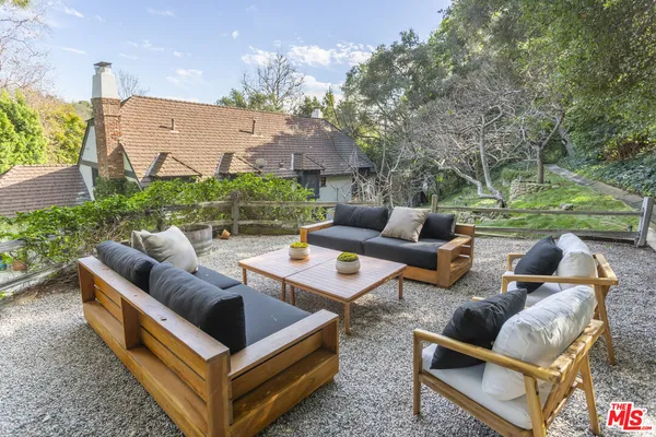 a view of a patio with couches chairs and a fire pit