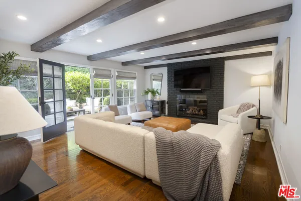 a living room with fireplace furniture and a flat screen tv