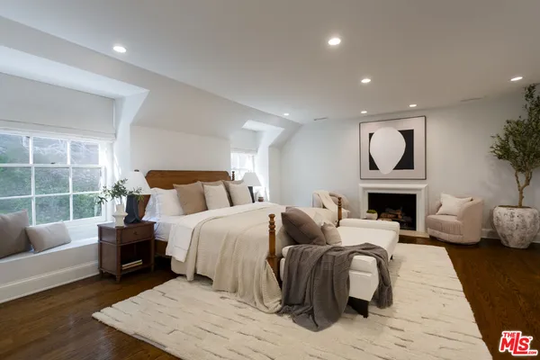 a bed room with a bed and a fireplace
