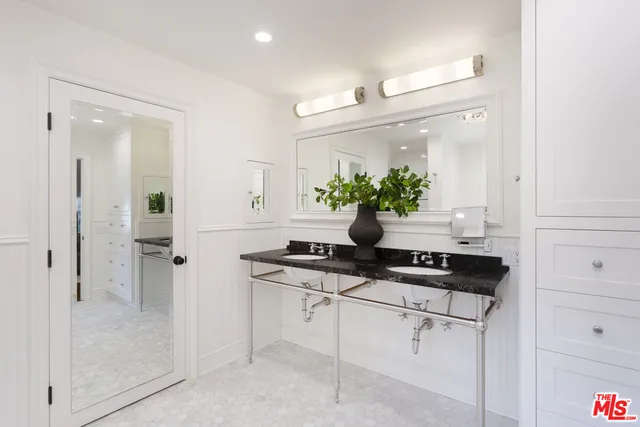 a view of kitchen with a sink and refrigerator