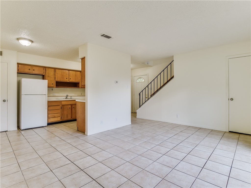 2804 Westhill Drive, Unit 101 Austin, TX 78704 - Photo 2 of 8 a view of a kitchen with a sink and an empty room