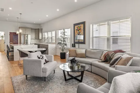 a living room with furniture and large windows