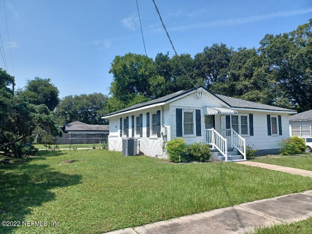 4808 Dundee Road Jacksonville, FL 32210 - Photo 2 of 7 a front view of a house with a garden and trees