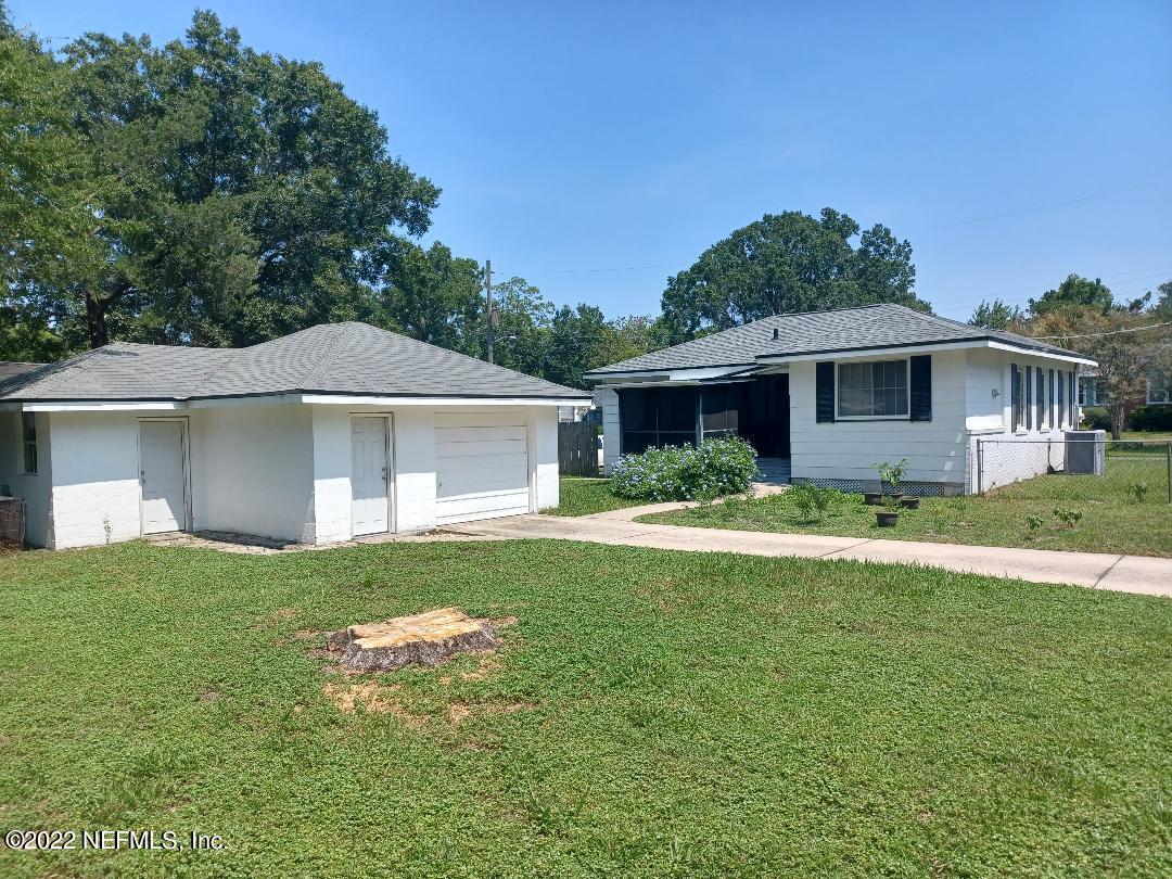 4808 Dundee Road Jacksonville, FL 32210 - Photo 3 of 7 a front view of a house with a yard and garage