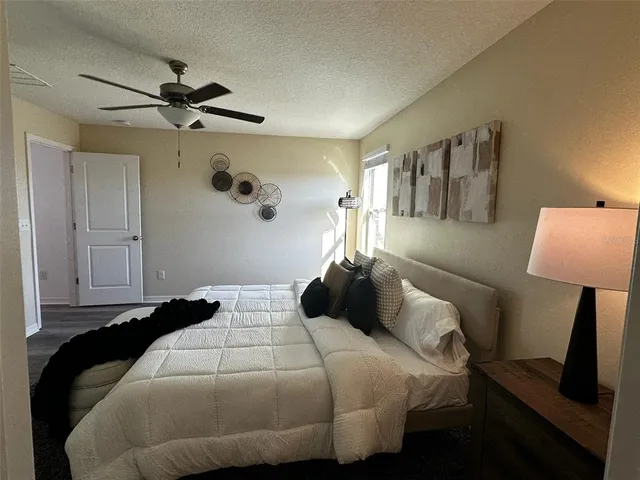 a bedroom with a bed and a lamp