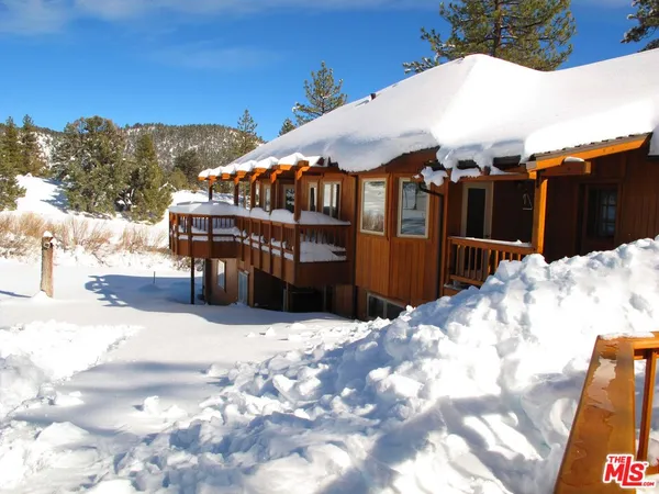 a view of a house with a snow in the yard