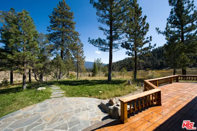 a view of a backyard with sitting area
