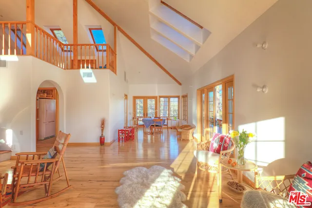 a view of living room filled with furniture and floor to ceiling windows