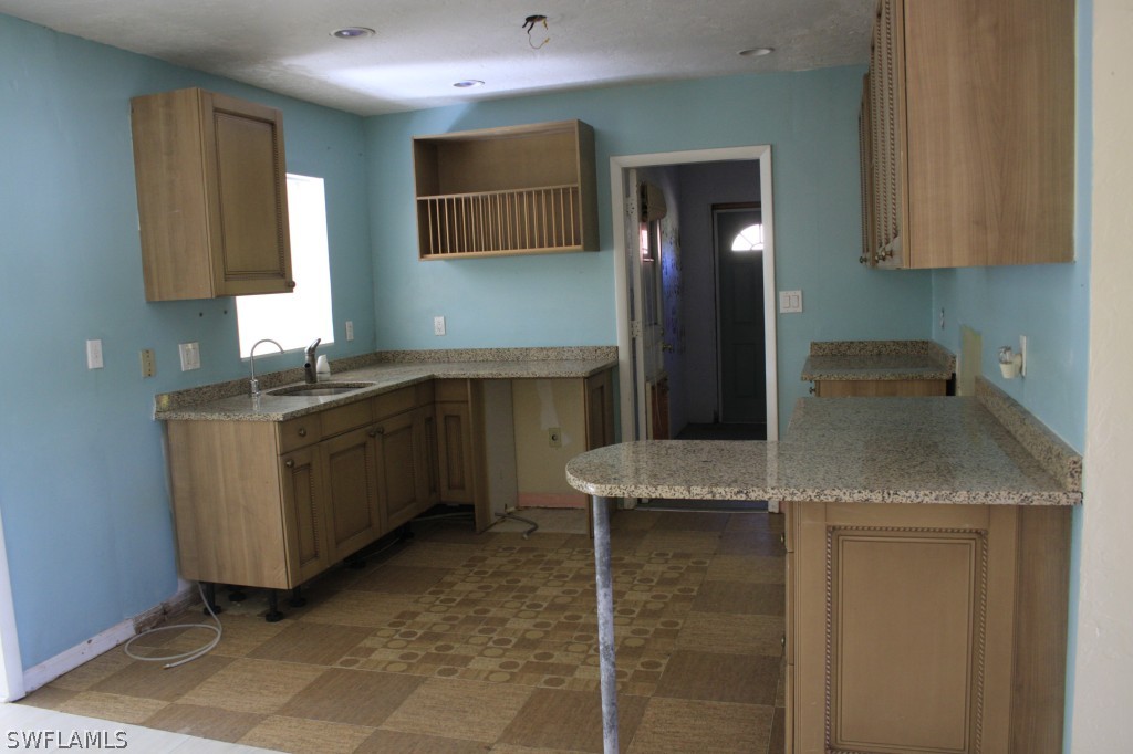 1428 Byron Road Fort Myers, FL 33919 - Photo 3 of 10 a kitchen with a sink a cabinets and window