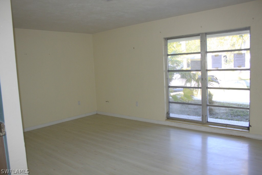 1428 Byron Road Fort Myers, FL 33919 - Photo 5 of 10 an empty room with wooden floor and windows