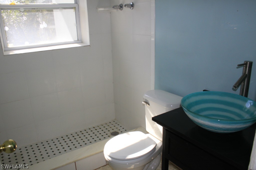 1428 Byron Road Fort Myers, FL 33919 - Photo 8 of 10 a bathroom with a toilet a sink and a window