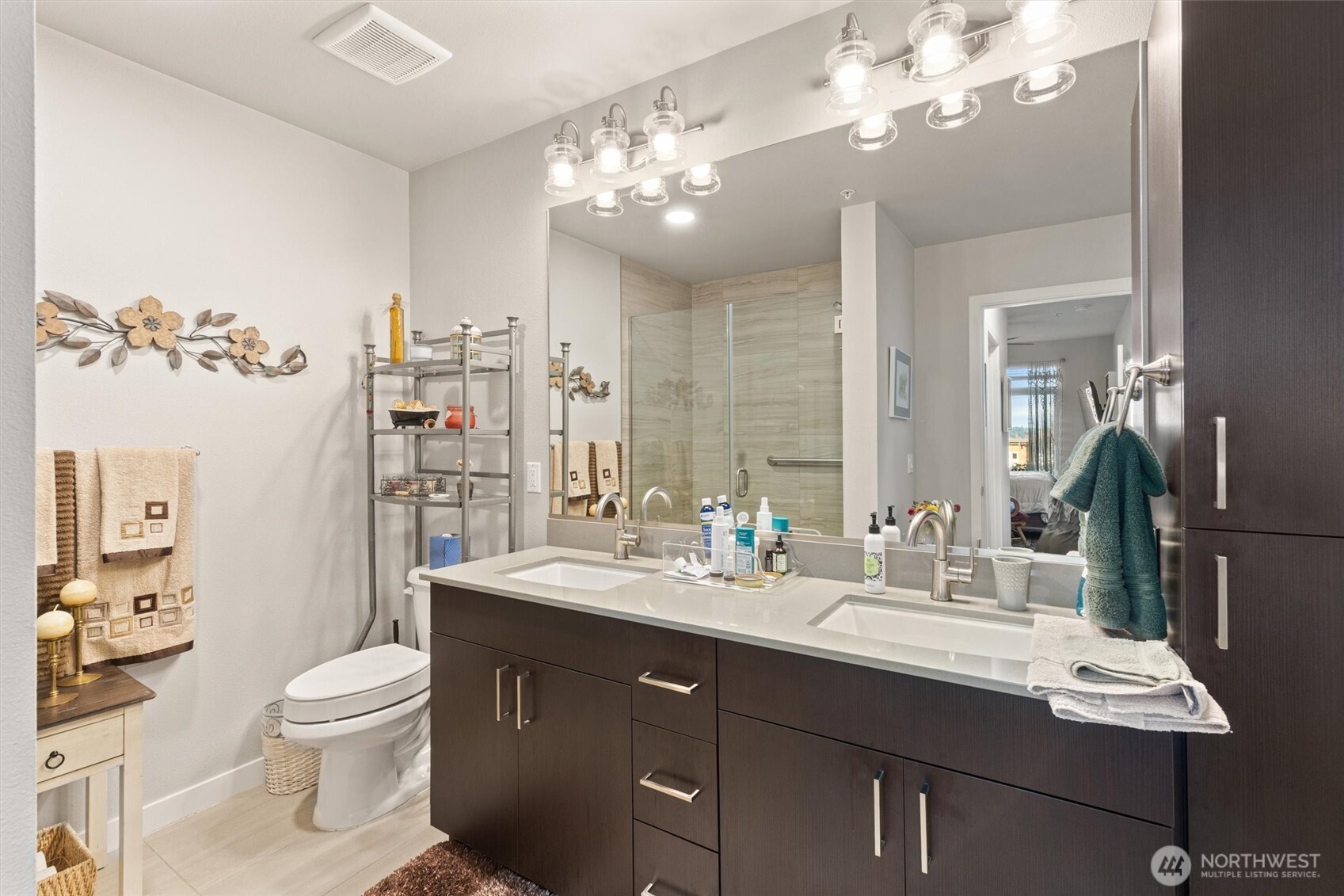 50 Pine Street, Unit 103 Edmonds, WA 98020 - Photo 20 of 40 a bathroom with a toilet a sink a light fixture and a mirror