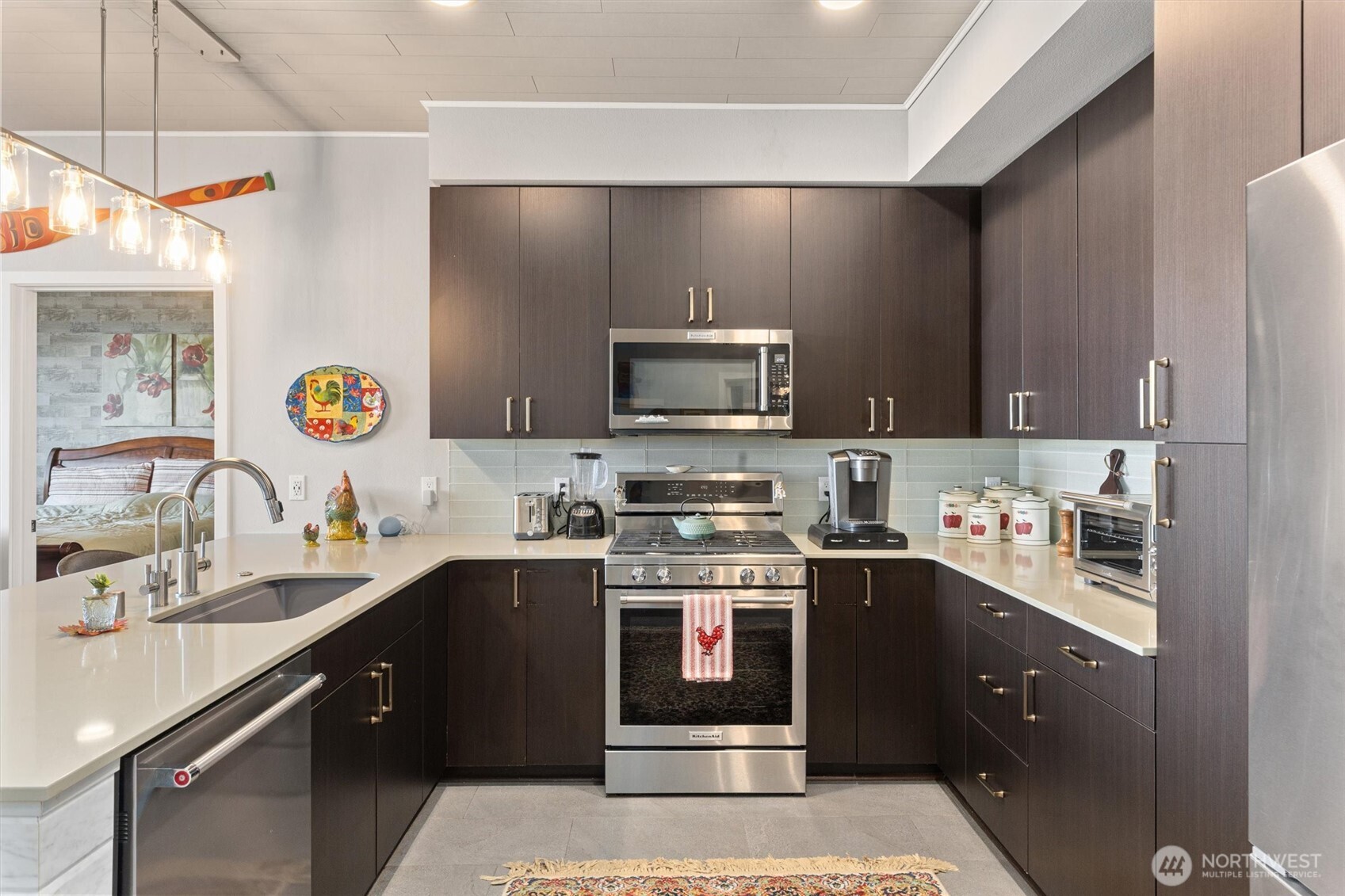 50 Pine Street, Unit 103 Edmonds, WA 98020 - Photo 4 of 40 a kitchen with stainless steel appliances granite countertop a sink and a stove
