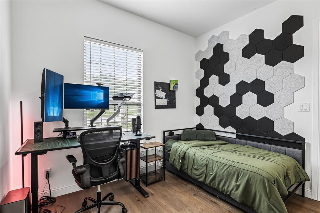 515 West Laureland Road Dallas, TX 75232 - Photo 11 of 32 a bedroom with a bed and a window
