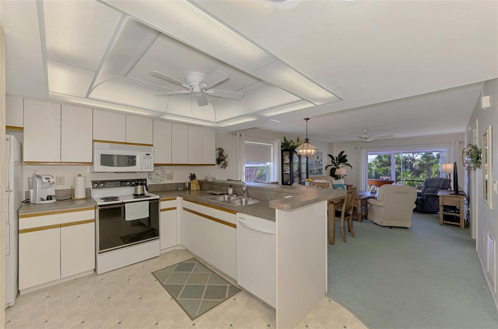 6800 Placida Road, Unit 146 Englewood, FL 34224 - Photo 15 of 64 a kitchen with a sink a stove top oven and cabinets