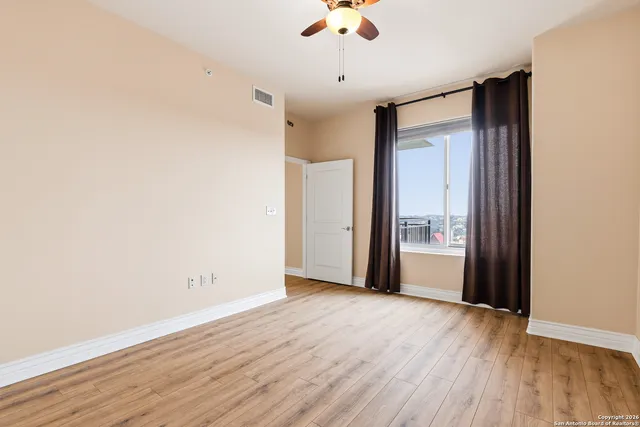 wooden floor in an empty room and a window