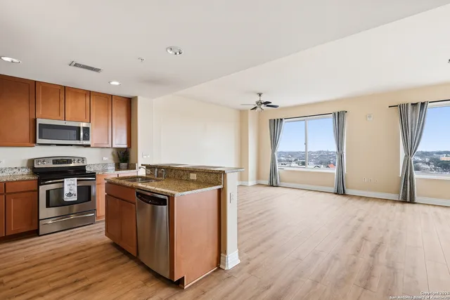 a kitchen with stainless steel appliances granite countertop a stove top oven and sink