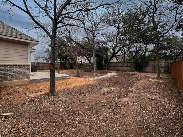 a view of a yard with trees