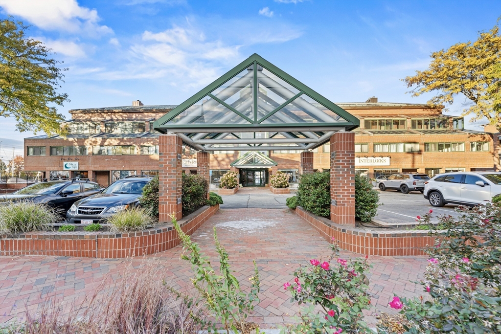 a view of a porch with a table and chairs under an umbrella