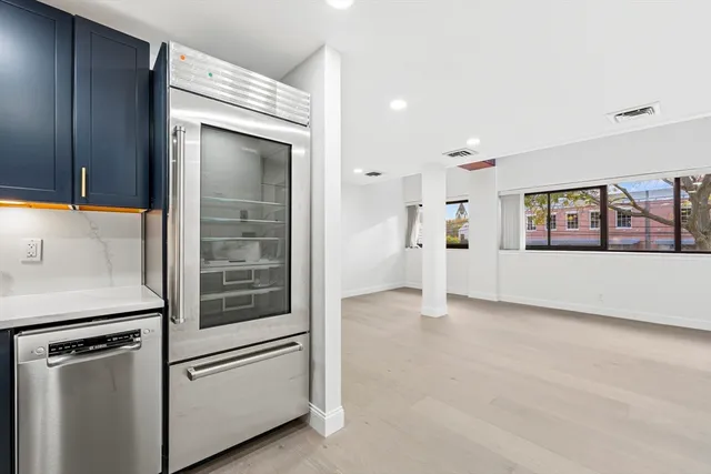 a view of a kitchen with a refrigerator cabinet and a dishwasher