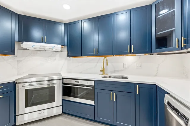 a kitchen with a sink stove and cabinets