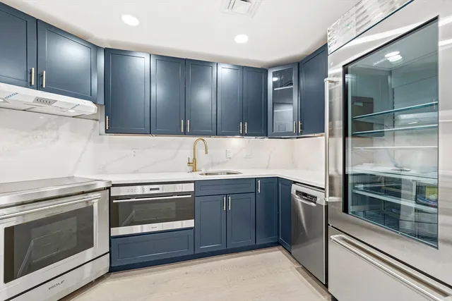 a kitchen with a sink and stainless steel appliances